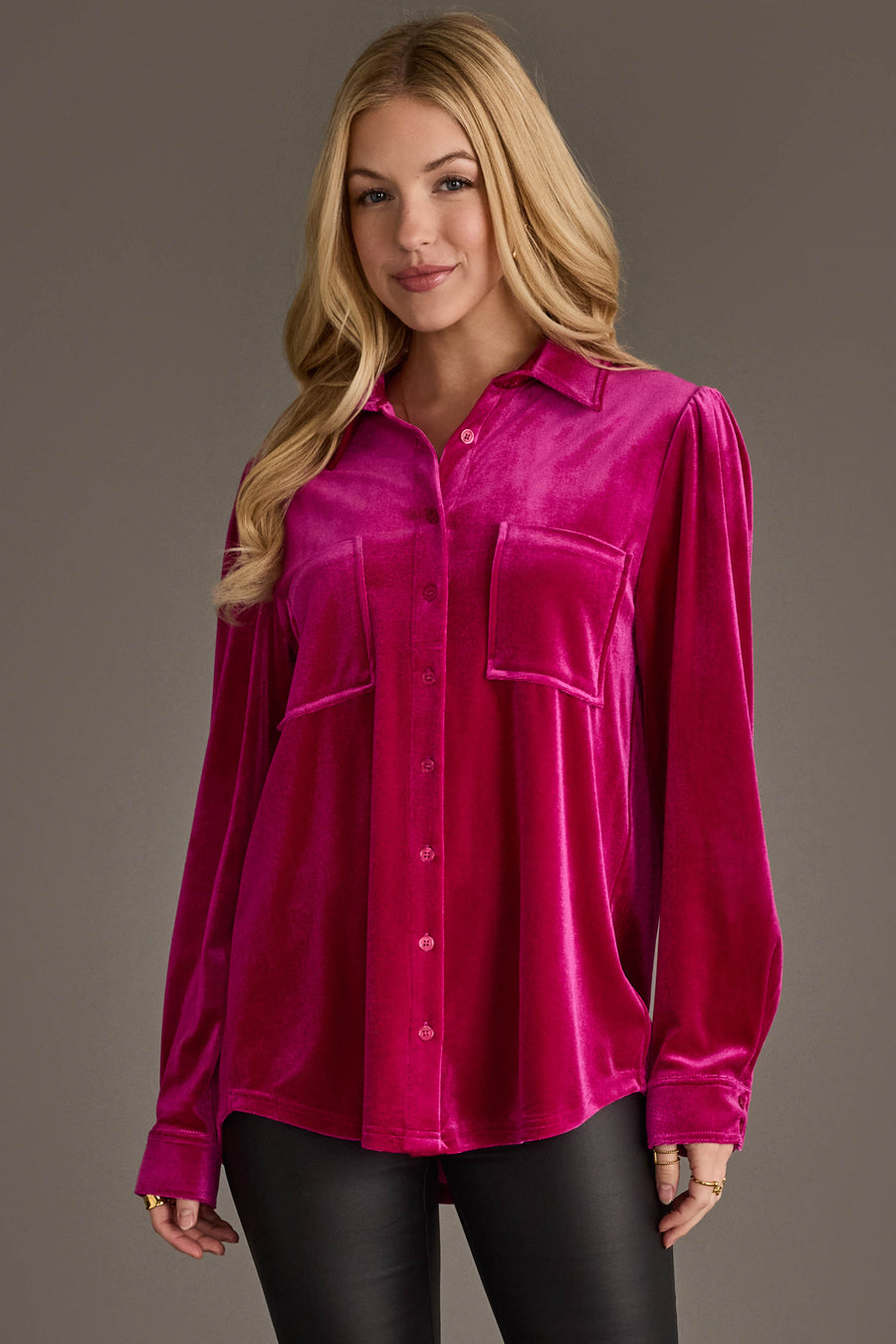 A woman with long blonde hair wears the Panache Apparel Collection Fuchsia Velvet Button Up with black pants, standing against a plain gray background.
