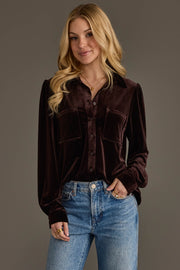 A woman with long blonde hair wears the Panache Apparel Collection Espresso Brown Velvet Button Up and blue jeans, standing against a plain background and smiling slightly with one hand in her pocket.