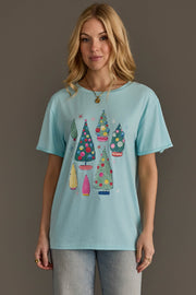 A light blue Light Blue Christmas Trees Tee featuring a colorful print of several decorated trees.