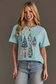 A light blue Panache Apparel Collection Light Blue Christmas Trees short-sleeved crew neck tee featuring a print of colorful illustrated holiday trees.
