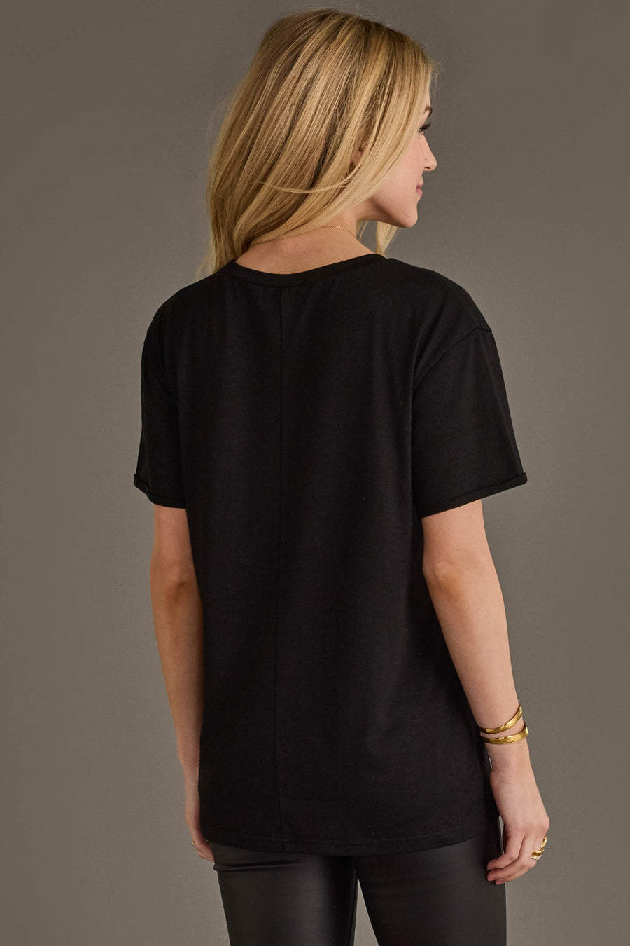 Back view of woman wearing Panache Apparel’s black If Lost, Return To Nearest Bar western graphic tee.