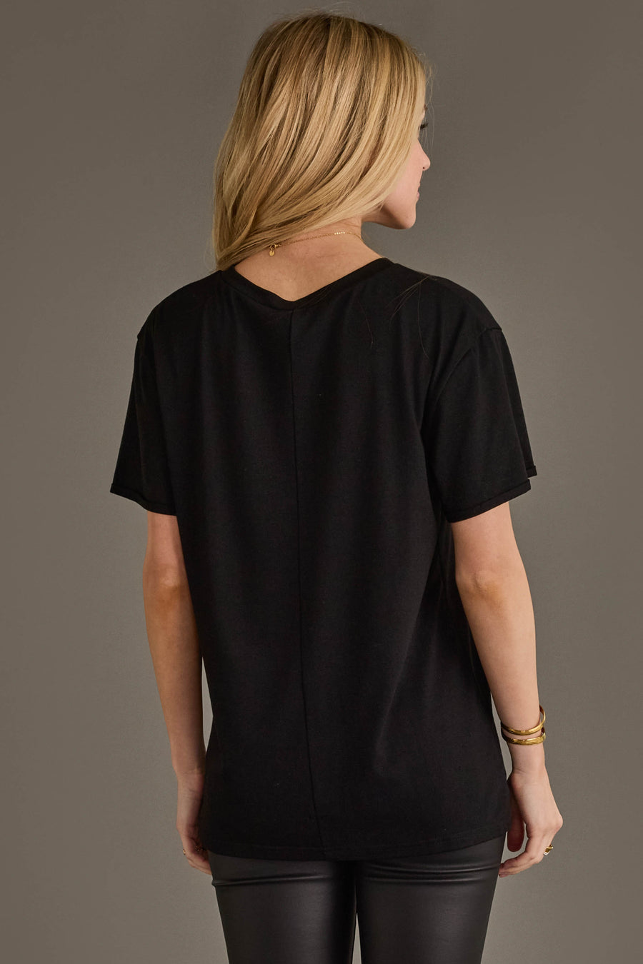 Back view of woman wearing Panache Apparel’s black Jesus Saves I Spend graphic tee.