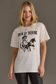 Woman wearing Panache Apparel’s white Hold Your Horses western graphic tee.