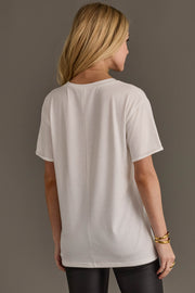 Back view of woman wearing Panache Apparel’s white Hold Your Horses western graphic tee.