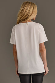 Back view of a person wearing a white Tis The Season To Be Tipsy Tee with a center back seam and black pants.