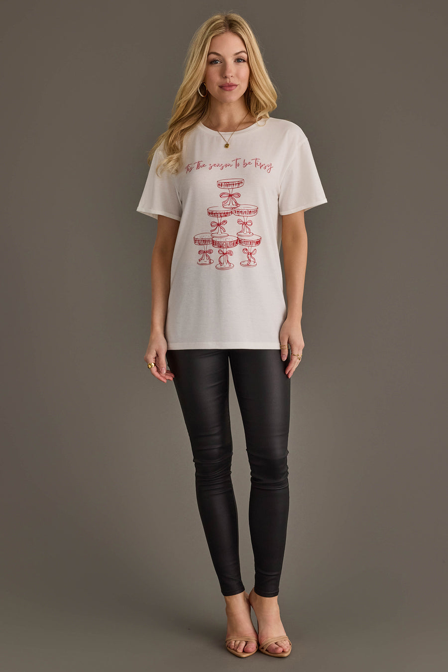 Panache Apparel Collection Tis The Season To Be Tipsy Tee, a white short-sleeved holiday graphic shirt featuring a red champagne tower illustration and the text, Tis the season to be tipsy.