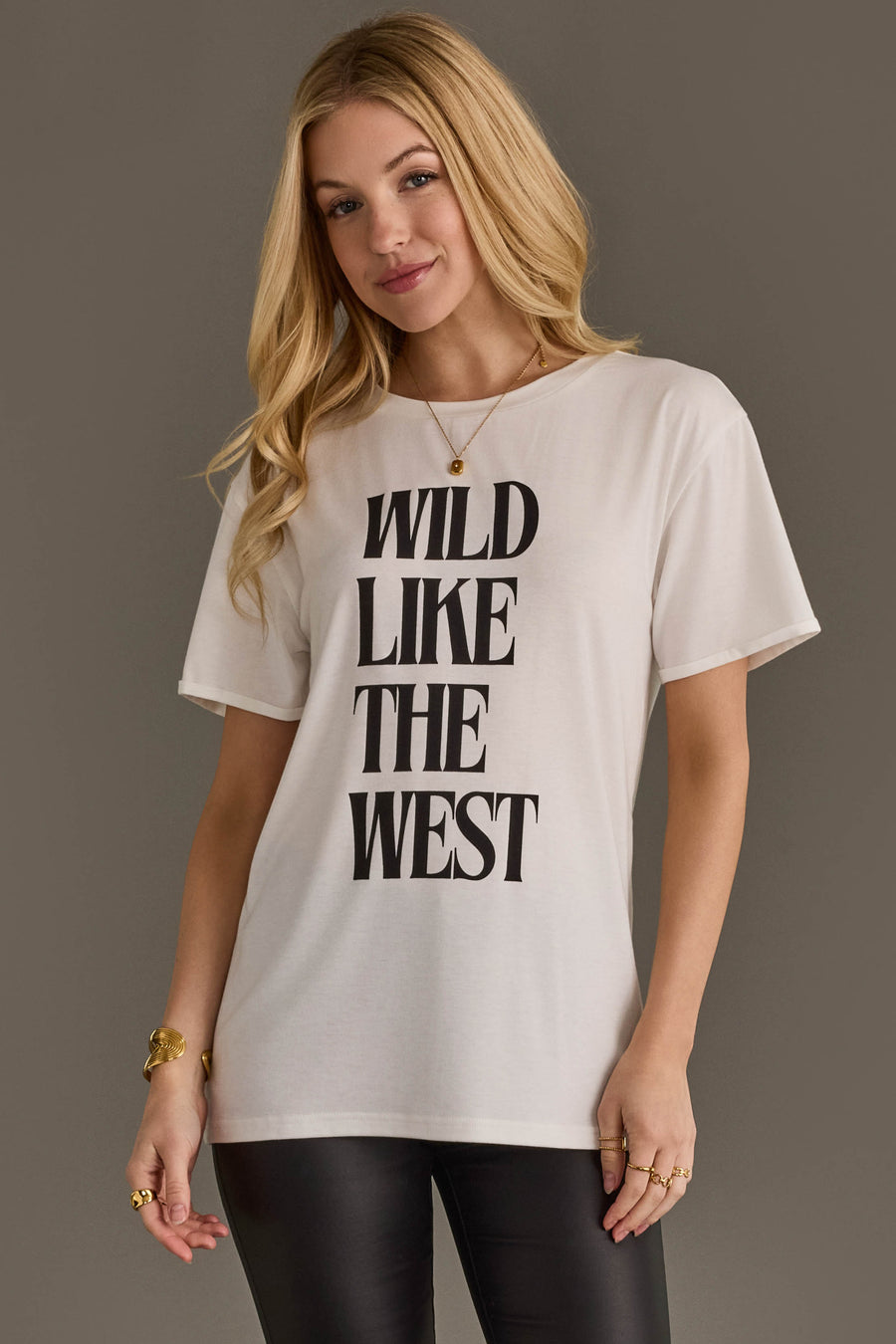 Woman wearing Panache Apparel’s white Wild Like The West western graphic tee.