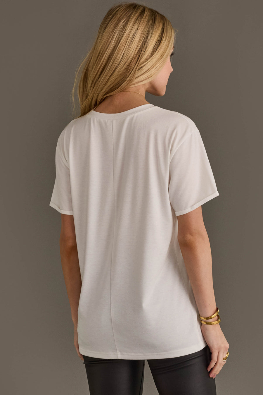 Back view of woman wearing Panache Apparel’s white Wild Like The West western graphic tee.