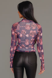 Model with long dark hair wearing the Panache Apparel Collection Reddish Brown Floral Mesh Top and black leather pants, shown from the back against a plain gray background.