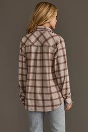 A person with long blonde hair wears the Panache Apparel Collection Light Taupe & Brown Plaid Button Up and light blue jeans, standing with their back to the camera against a plain gray background.