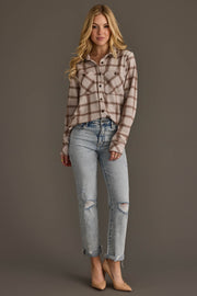 A woman stands against a plain background wearing the Panache Apparel Collection Light Taupe & Brown Plaid Button Up with light blue ripped jeans and beige heels. She has long, wavy blonde hair and a slight smile.