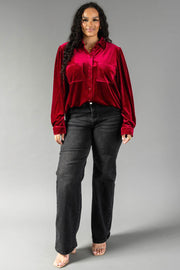A person wearing a relaxed fit Burgundy Velvet Button Up shirt from Panache Apparel Collection paired with black wide-leg jeans.