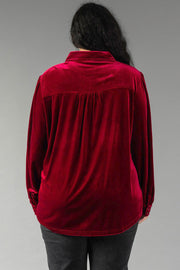 Back view of a person wearing a Burgundy Velvet Button Up, featuring long sleeves, a collared neckline, and a pleated back yoke.