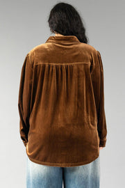 Back view of the Bronze Velvet Button Up in bronze velvet, featuring a pleated back yoke and worn with light wash jeans.