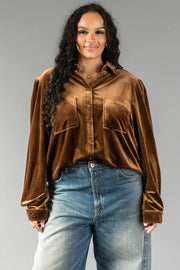 A Bronze Velvet Button Up shirt in bronze with long sleeves and two chest pockets, worn with blue jeans.