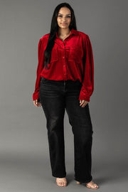 A woman wearing a red velvet Red Velvet Button Up shirt and black jeans.