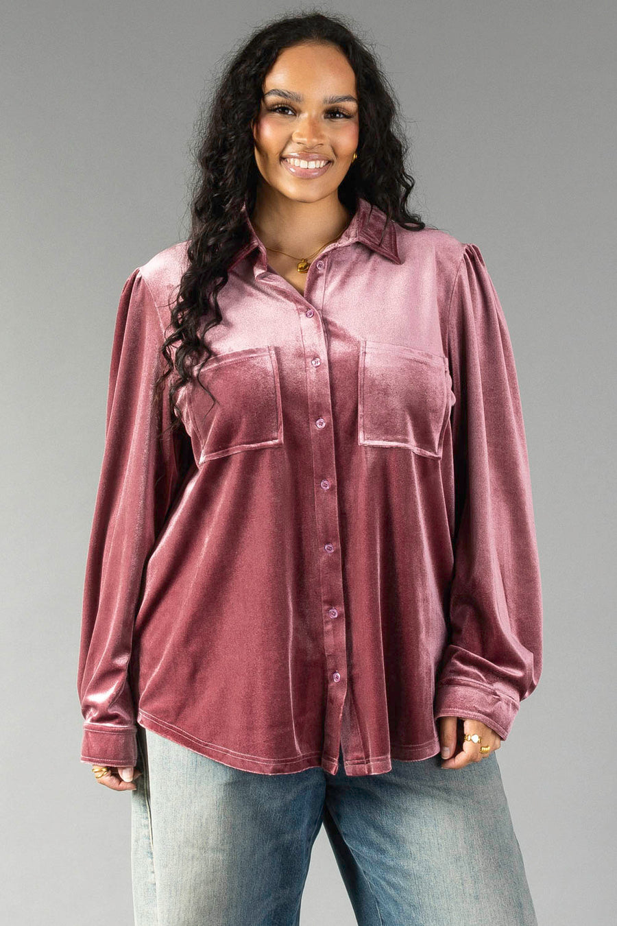 A woman wearing a Panache Apparel Collection Mauve Velvet Button Up with chest pockets and light wash jeans.