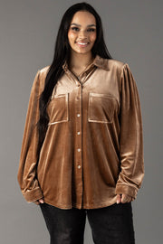 A smiling person wearing a tan velvet button-up Tan Velvet Button Up shirt with two chest pockets.