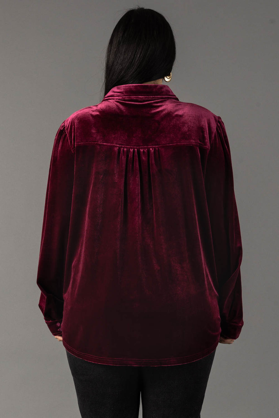 Back view of a person wearing a Maroon Velvet Button Up shirt in maroon velvet with a pleated back yoke.