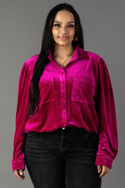 A person wearing a Panache Apparel Collection Fuchsia Velvet Button Up, a long-sleeved shirt with a collar, two chest pockets, and a fuchsia velvet finish.