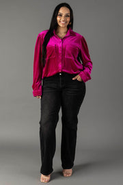 A person wearing a Panache Apparel Collection Fuchsia Velvet Button Up with two chest pockets and dark jeans.