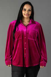 A person wearing a Panache Apparel Collection Fuchsia Velvet Button Up, a long-sleeved shirt with two chest pockets.