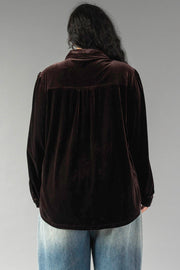 Back view of a person wearing an Espresso Brown Velvet Button Up with a back yoke and pleated detail, paired with light-wash jeans.