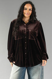A person wearing an Espresso Brown Velvet Button Up with two front chest pockets and blue jeans.