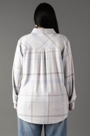 A person with long dark hair, seen from behind, wears the Panache Apparel Collection’s White, Gray & Light Blue Plaid Button Up and blue jeans against a plain gray background.