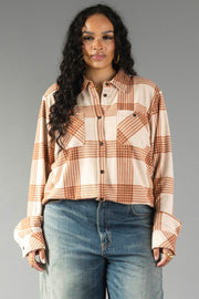 A woman with long curly hair wears the Panache Apparel Collection Cream & Rust Plaid Button Up and blue jeans, standing against a gray background.