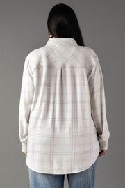 A person with long dark hair is seen from behind, wearing the Panache Apparel Collection White & Light Gray Plaid Button Up and blue jeans against a plain gray background.