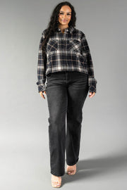 A woman models the Panache Apparel Collection Black, White & Tan Plaid Button Up, paired with black jeans and nude heels, as she stands against a plain gray background facing forward with a slight smile.