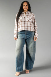 A woman stands against a gray background wearing the Panache Apparel Collection Light Taupe & Brown Plaid Button Up and wide-leg blue jeans with open-toe heels.