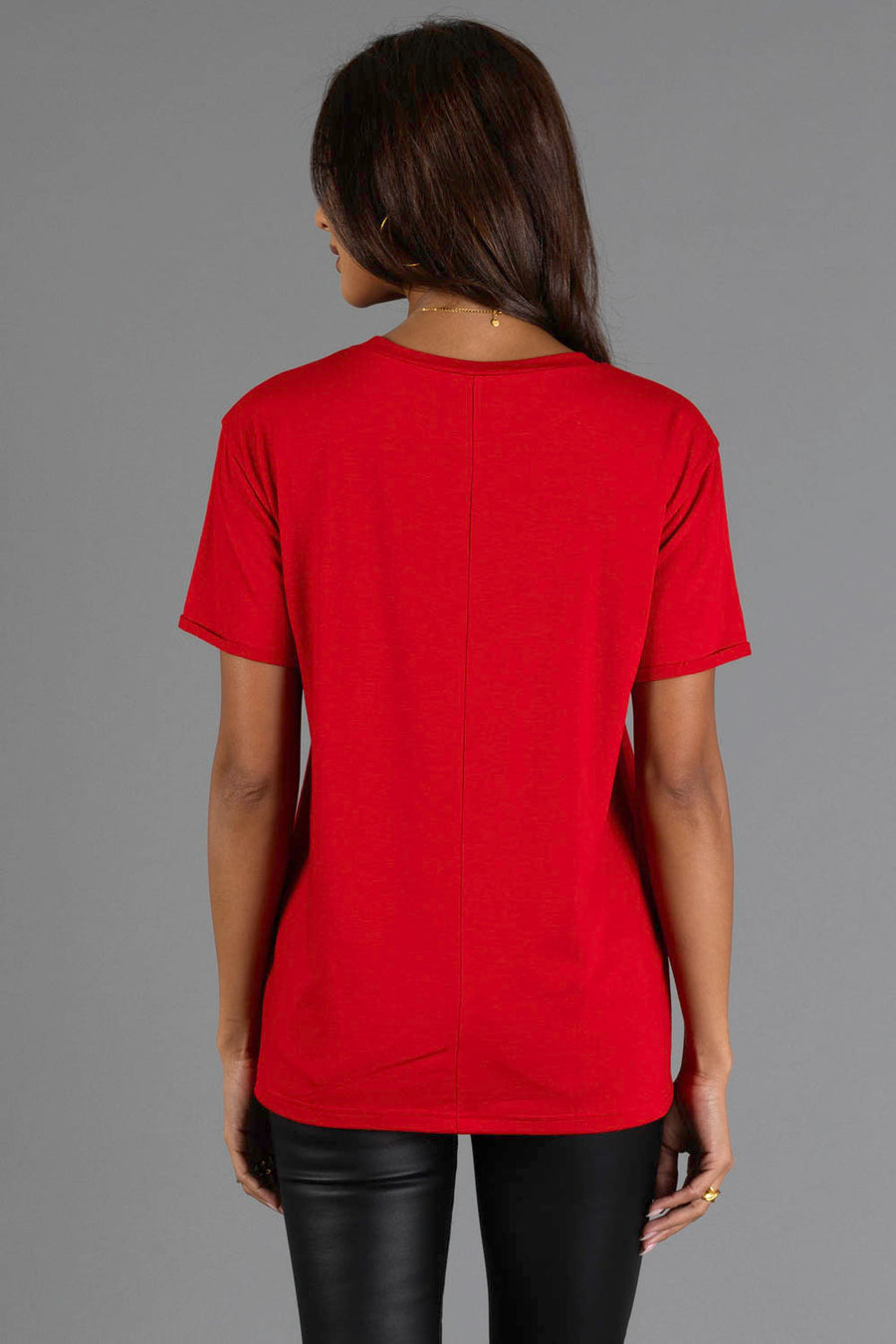 Back view of a person wearing a red, short-sleeved Christmas List Tee with a crew neck and a center back seam.