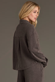 A woman wearing a Cocoa Cropped Washed Soft Button Up in cocoa with a box pleat on the back.