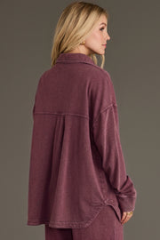A woman viewed from the back wearing a Merlot Washed Soft Button Up in a soft, merlot-washed fabric with a collared neckline and a pleated back yoke.