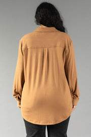 Back view of a person wearing a Dark Tan Super Soft Button Up, featuring a long-sleeve, dark tan design with a back yoke and pleat.