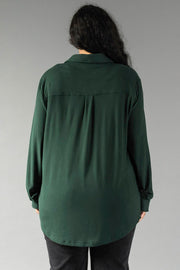 Back view of a person wearing a Hunter Green Super Soft Button Up, a long-sleeved shirt with a pleated back yoke and a curved hem.