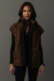A woman models the Panache Apparel Collection Brown & Black Leopard Fleece Vest over a black long-sleeve top, standing against a plain dark background and looking at the camera with a slight smile.