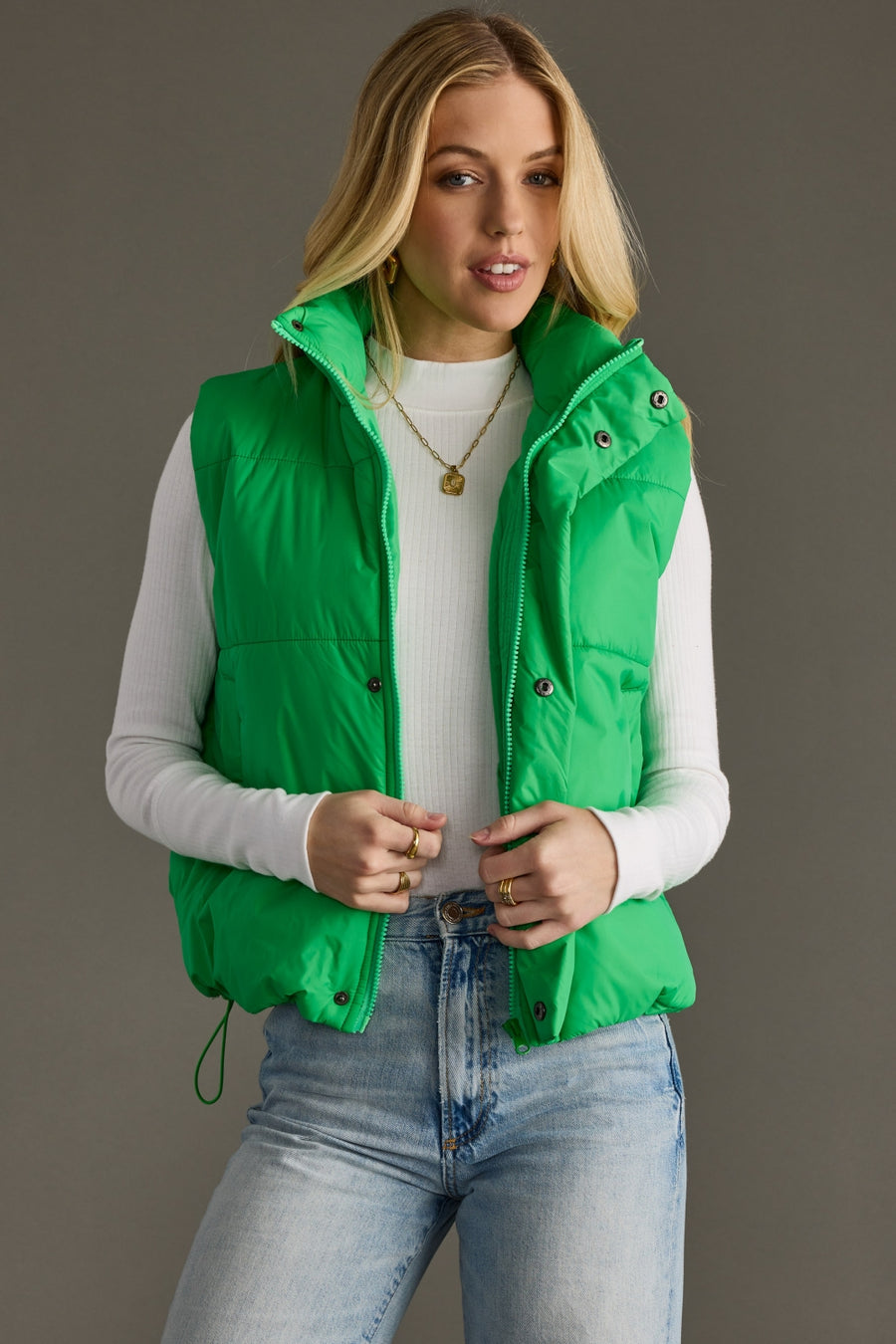 Woman wearing Panache Apparel’s Bright Green World Traveler quilted puffer vest with zip-front closure.