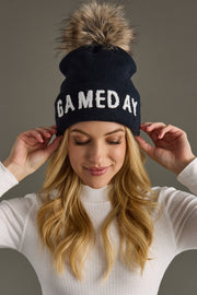 Woman wearing Panache Apparel’s navy and white Game Day pom hat.