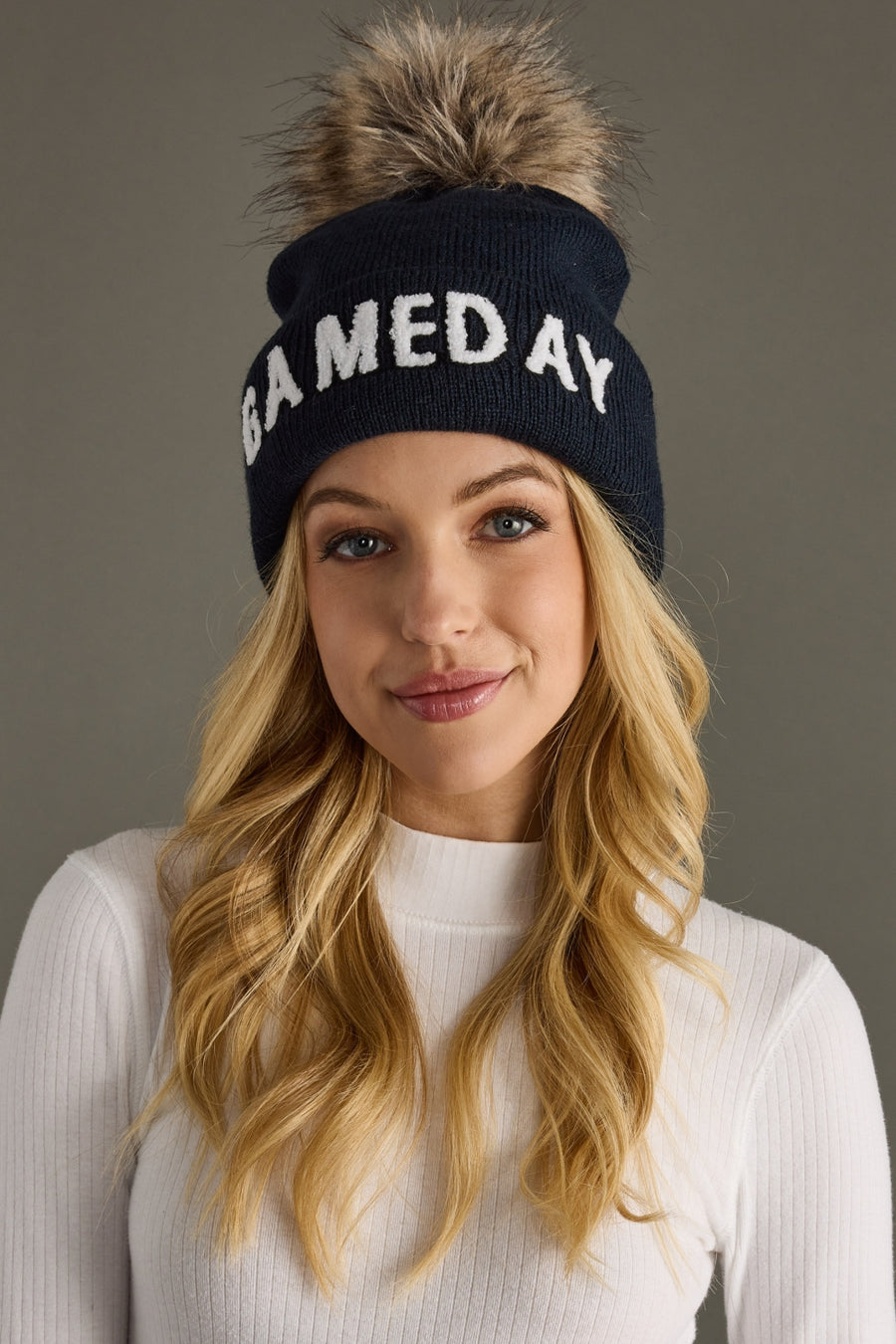 Front view of Panache Apparel’s navy and white Game Day pom hat.