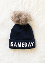 Flat lay of Panache Apparel’s navy and white Game Day pom hat.