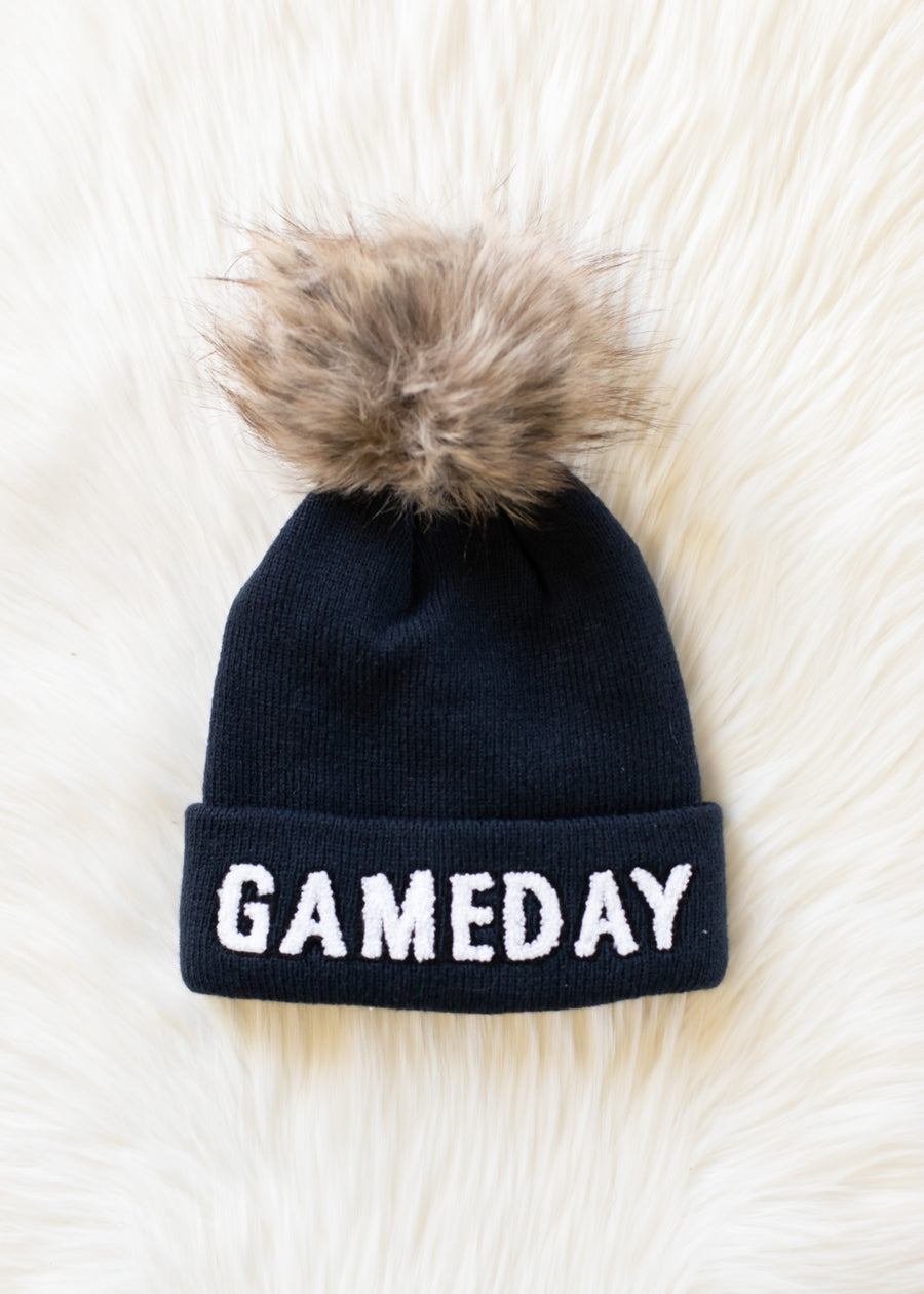 Flat lay of Panache Apparel’s navy and white Game Day pom hat.