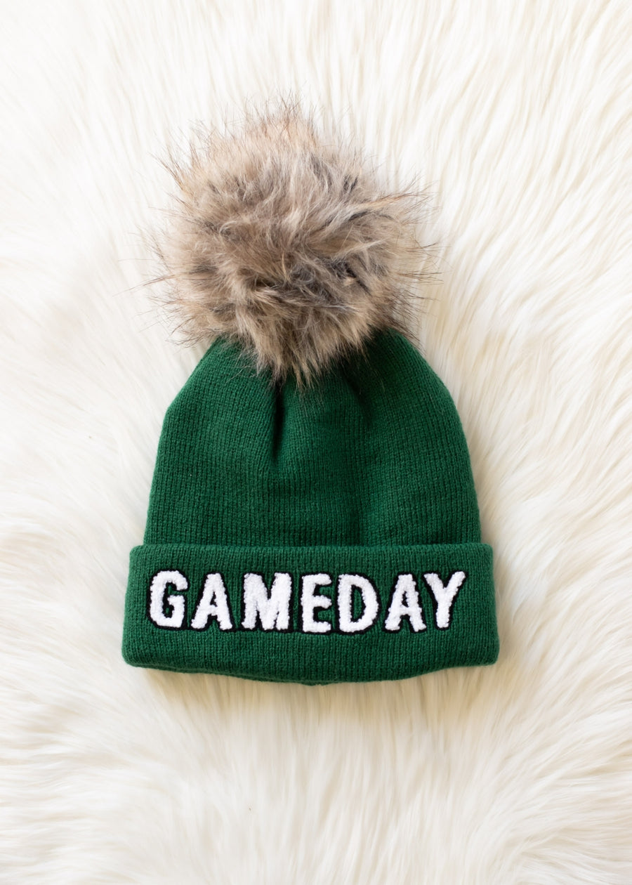 Flat lay of Panache Apparel’s green and white Game Day pom hat.
