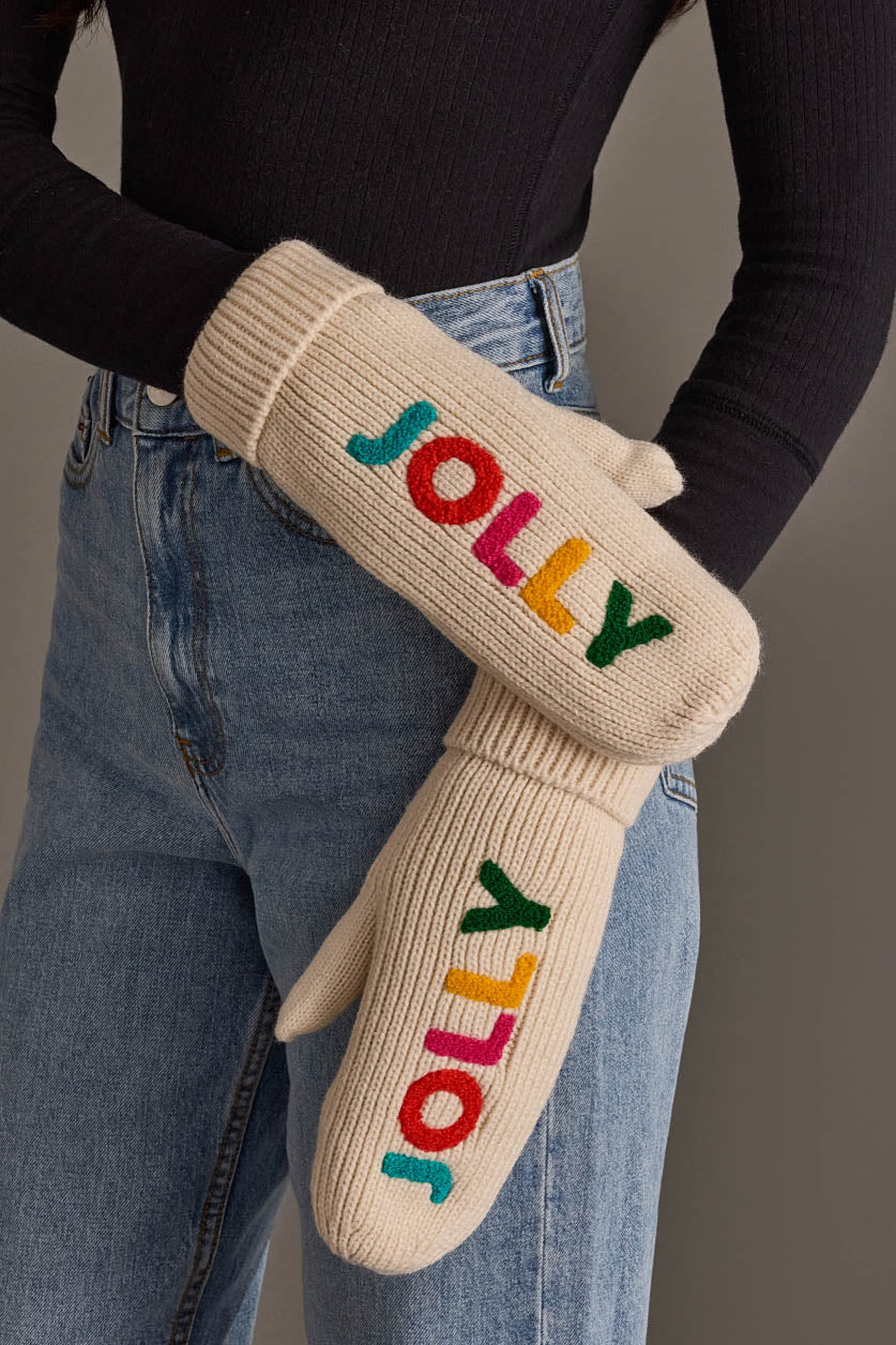 Beige Jolly Mittens by Panache Apparel Collection featuring the word JOLLY embroidered in multicolored letters on beige knit, fleece-lined for extra warmth.