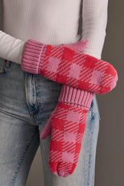 A person with arms crossed in front of their body is wearing Panache Apparel Collection’s Pink & Bright Pink Plaid Knit Mittens, a white ribbed long-sleeve top, and light-wash jeans.