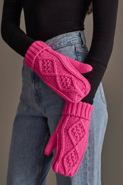 Model wearing the Panache Apparel Collection Bright Pink Cable Knit Mittens, paired with a black long-sleeve top and blue jeans, standing against a neutral background.