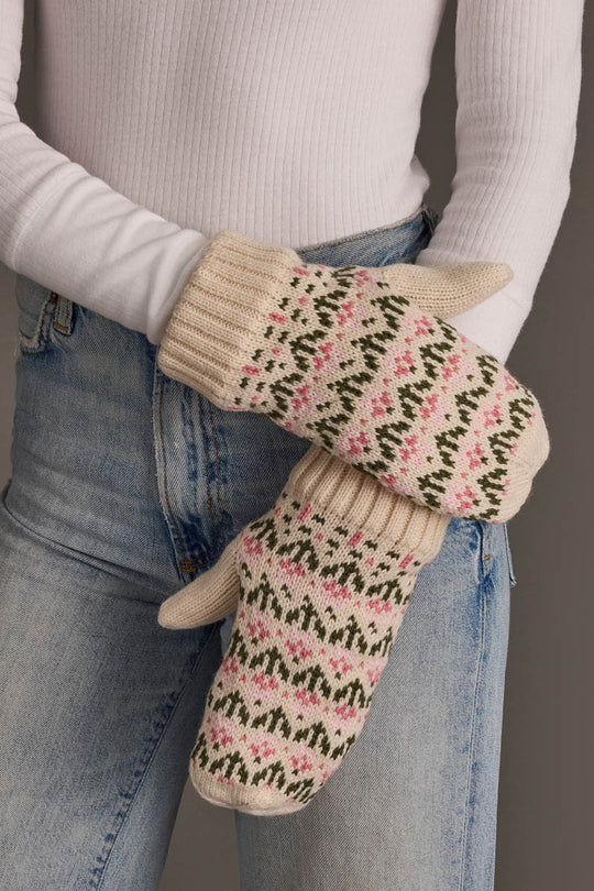 A person wearing blue jeans and a white ribbed sweater holds the Panache Apparel Collection Cream & Pink Floral Pattern Mittens.