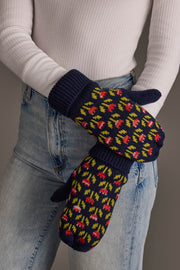 A person in a white ribbed top and light blue jeans is wearing the Panache Apparel Collection’s Navy Small Floral Pattern Knit Mittens, standing against a neutral background.